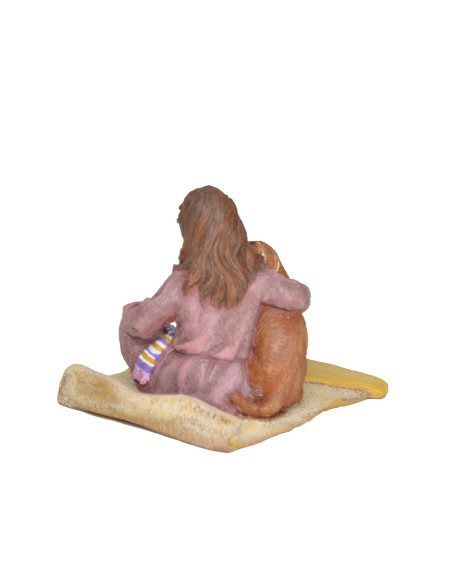 Niña sentada con perrito lamiendo la mejilla